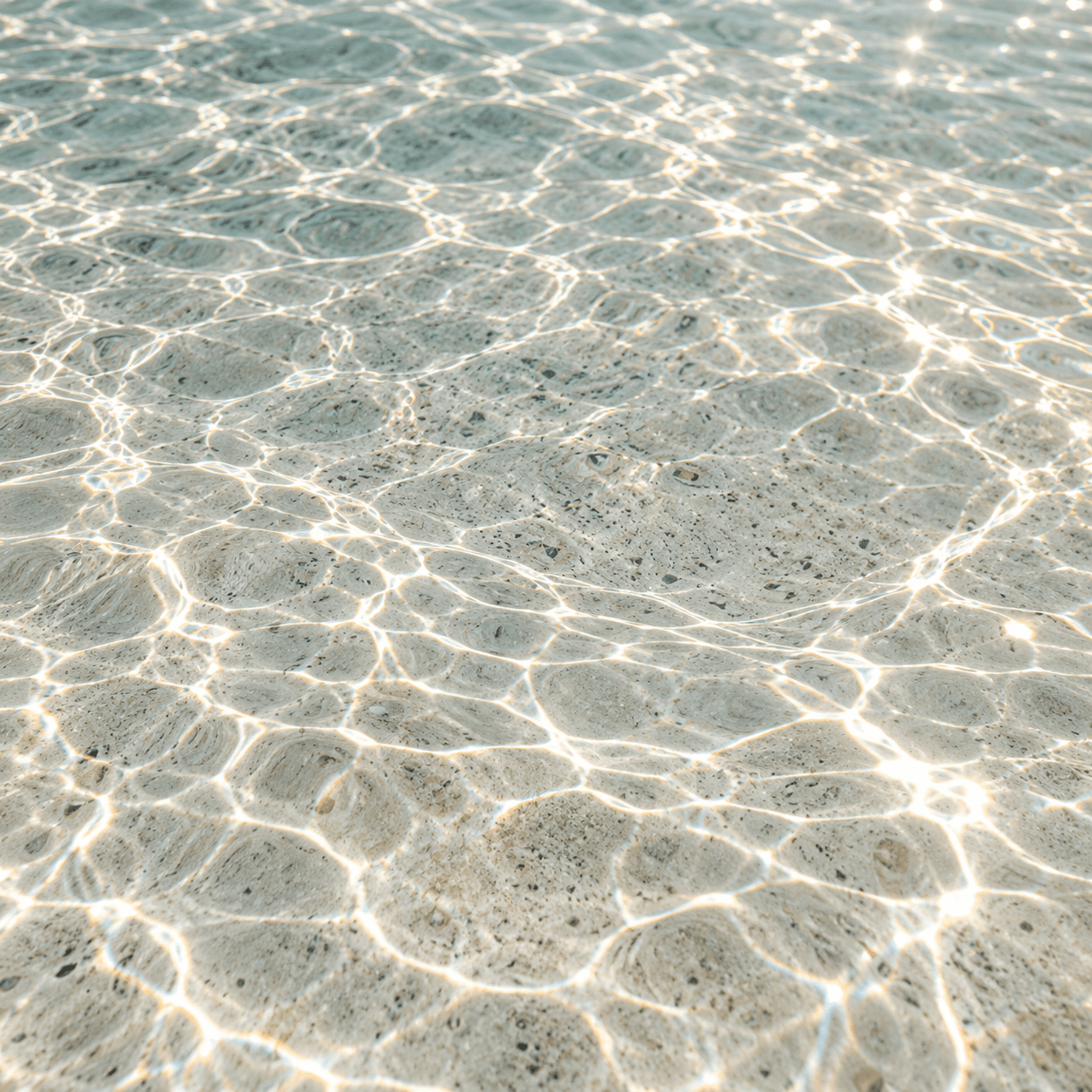 Daylight refracting through clear shallow water.