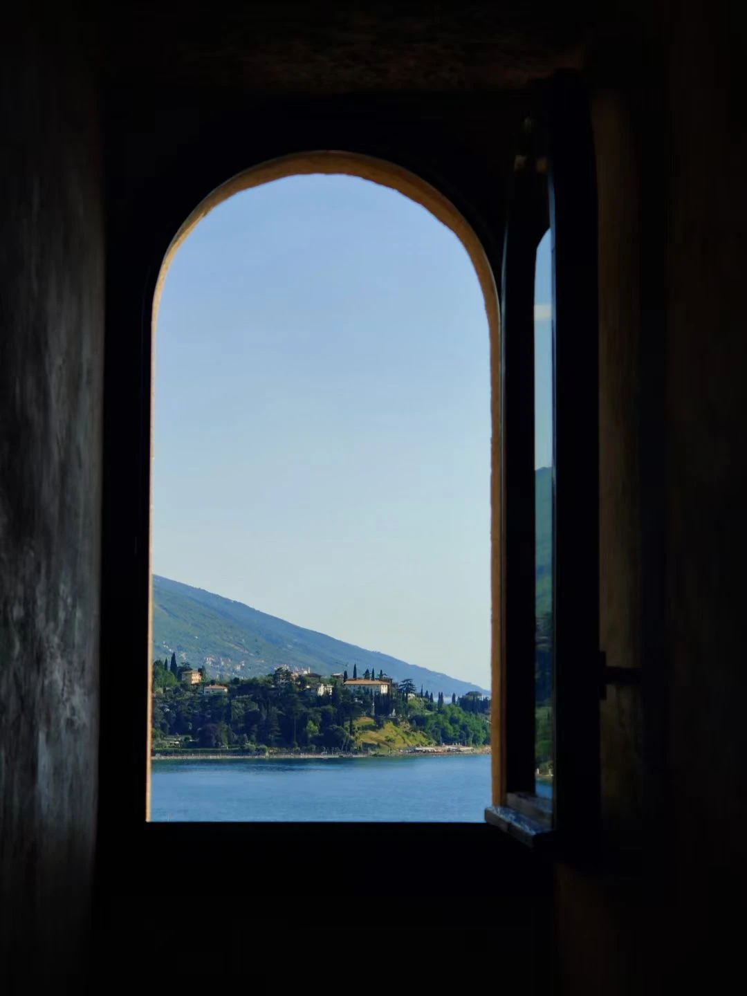 Lake and hills seen through an arched window