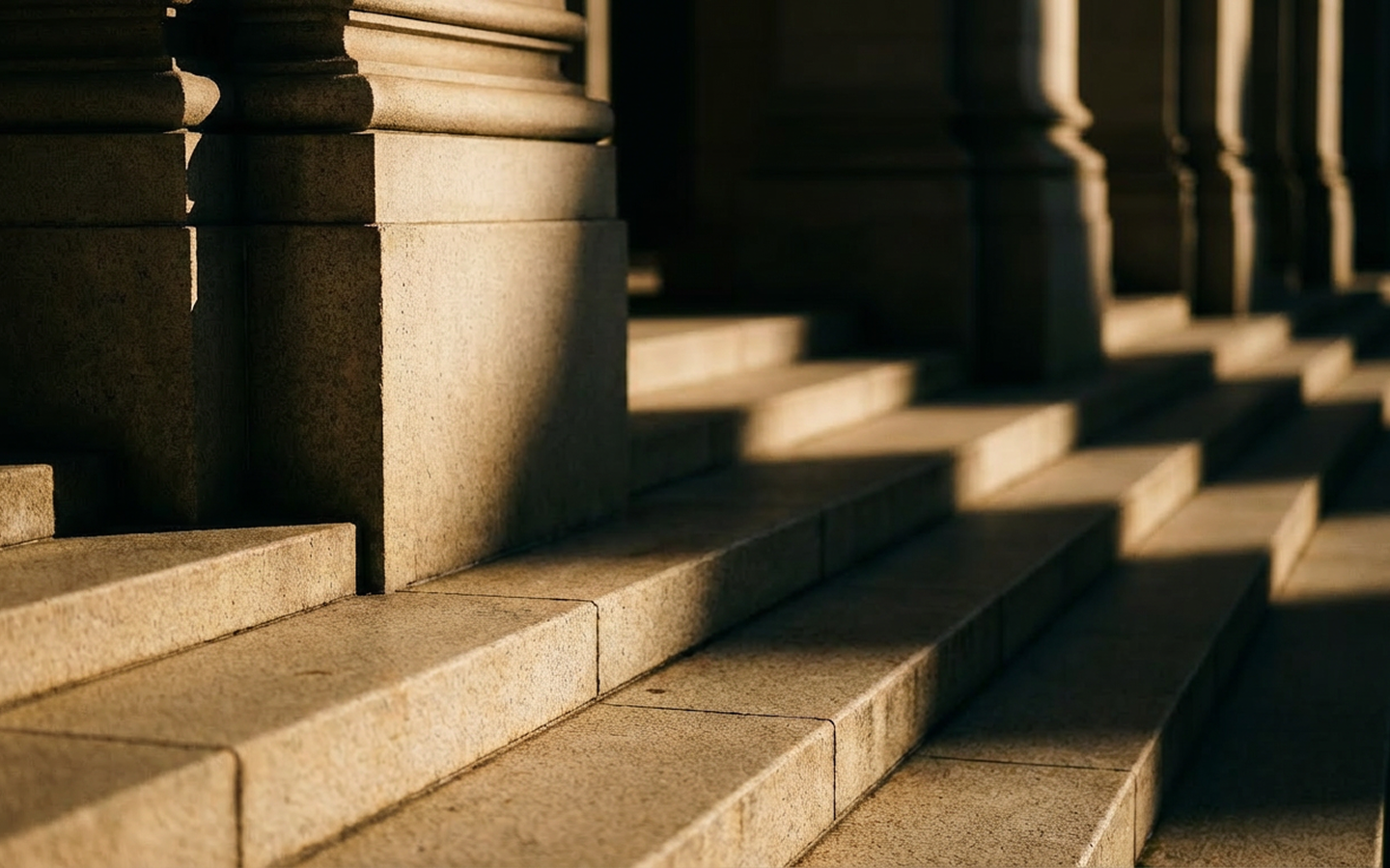 Closing storyboard frame: light and shadow across stone steps and columns.