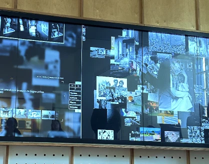 Existing MUNAF digital wall showing several photographs and descriptive information
